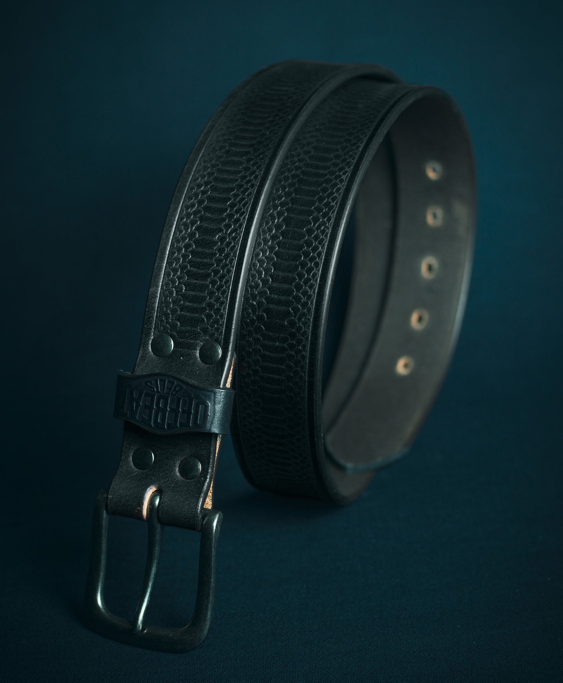 Y2k streetwear black leather belt with red Japanese fish embossed design on a dark background