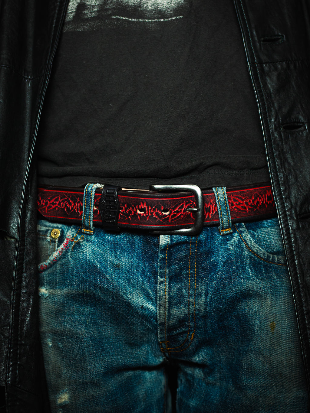 Model wearing Y2k streetwear red leather belt with sigil design