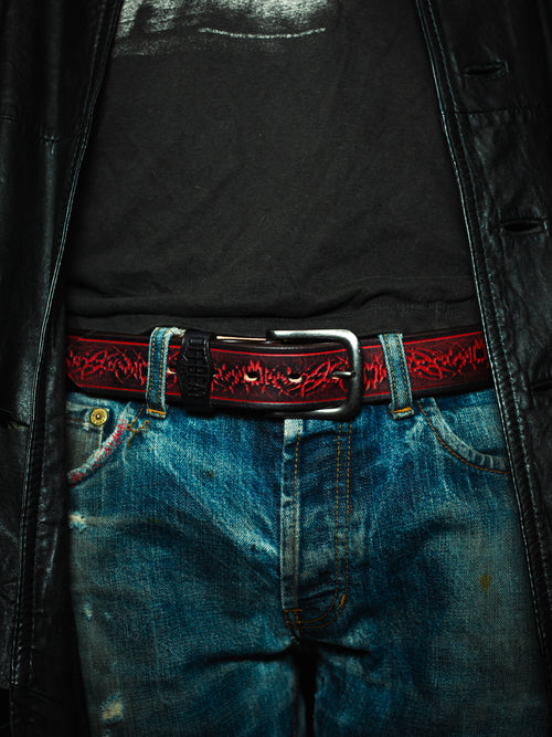 Model wearing Y2k streetwear red leather belt with sigil design