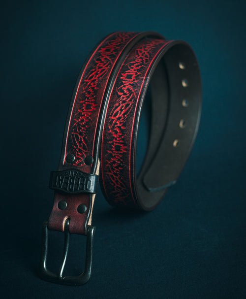Goth streetwear black leather belt with red sigil embossed design on a dark background