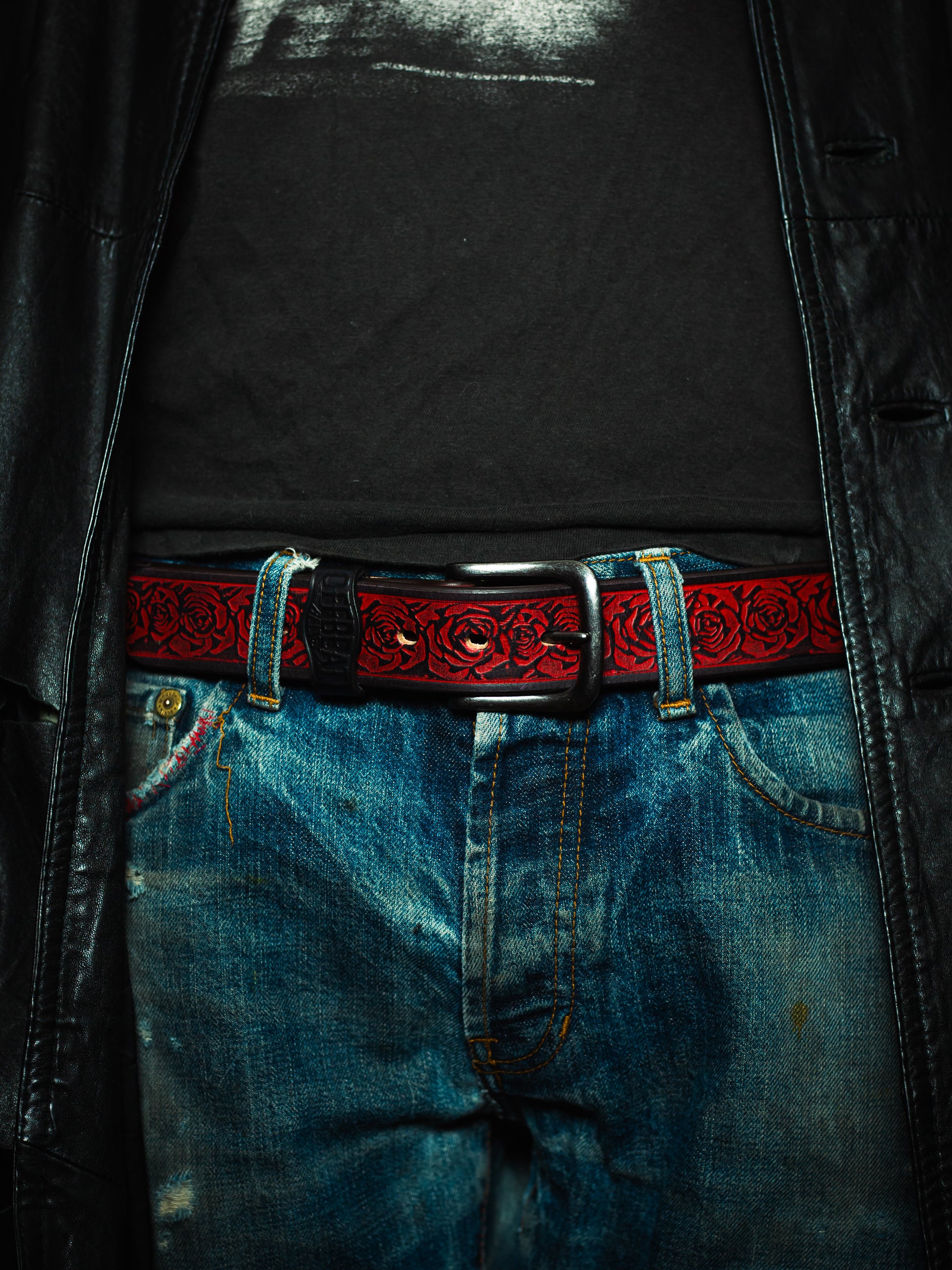 Model wearing a Y2k streetwear red leather belt with floral design