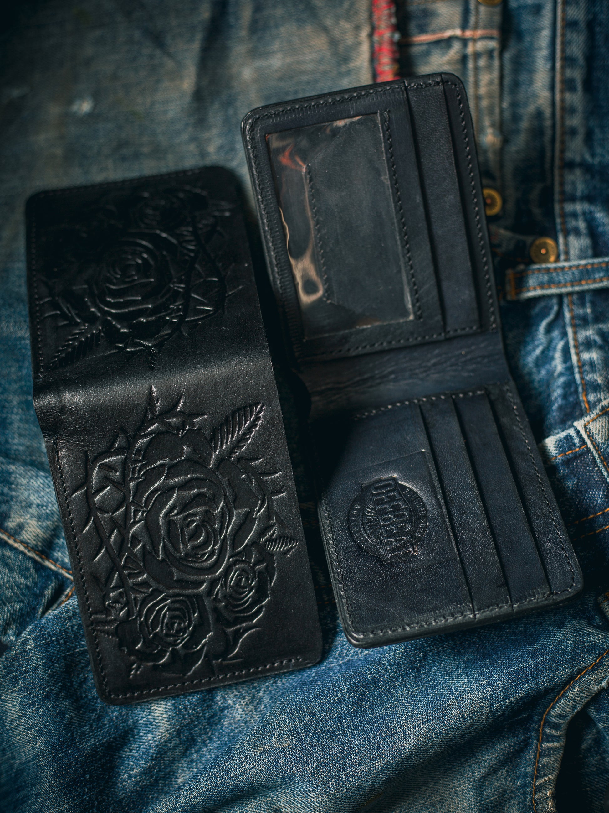 Front and back of handmade vintage black leather wallet with floral embossing