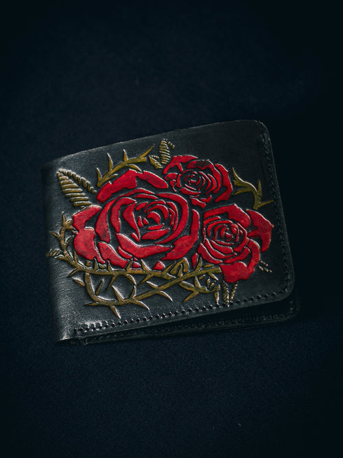 Closeup of handmade vintage red leather wallet with grunge-style floral embossing